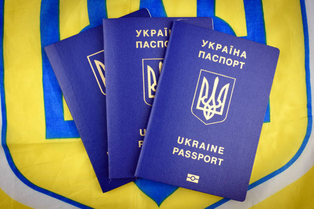 Ukrainian biometric passports Ukrainian biometric passports on national yellow-blue flag close-up blue us passport cover stock pictures, royalty-free photos & images
