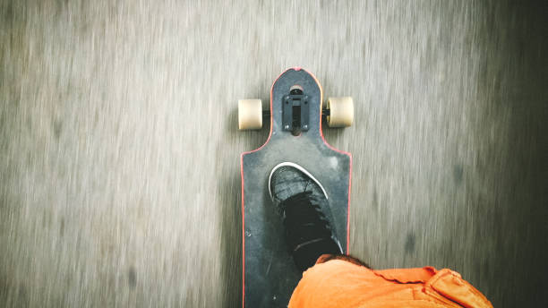 Cropped shot of a man riding a skateboard at high speed