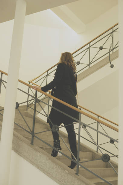 istock Young woman on stairs 895036844