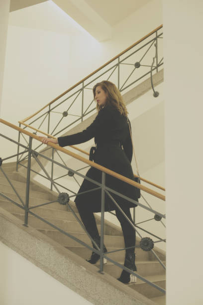 istock Young woman on stairs 895038974