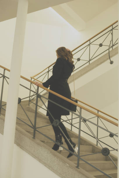istock Young woman on stairs 895038990