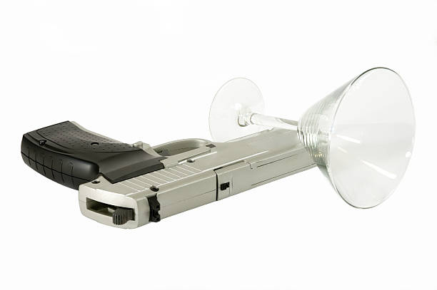 istock hand gun and cocktail glass 89503968