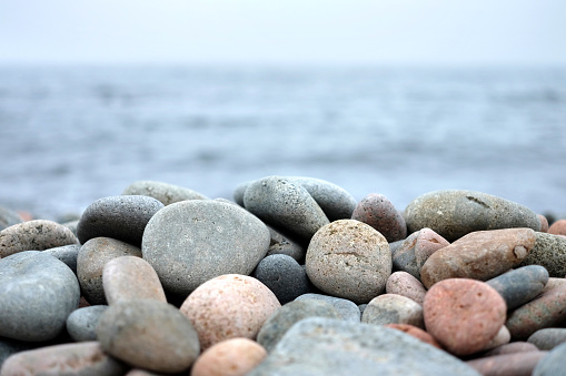 Round sea stones in front of sea water