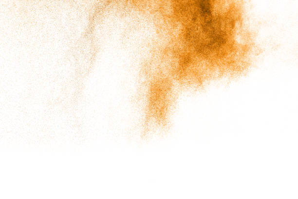 istock abstract orange dust explosion on white background. abstract orange powder splattered on white background, Freeze motion of orange powder splash. 895041928