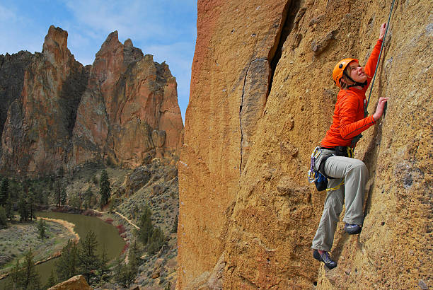 Terrebonne, OR, USA - October 06, 2025: Adventurous individuals are seen enjoying rock climbing on the iconic cliffs of Smith Rock State Park under a clear summer sky