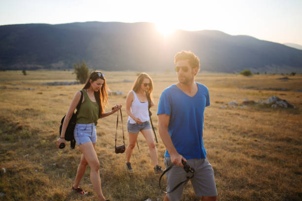 istock Young people enjoying walk in the beautiful nature 895048782