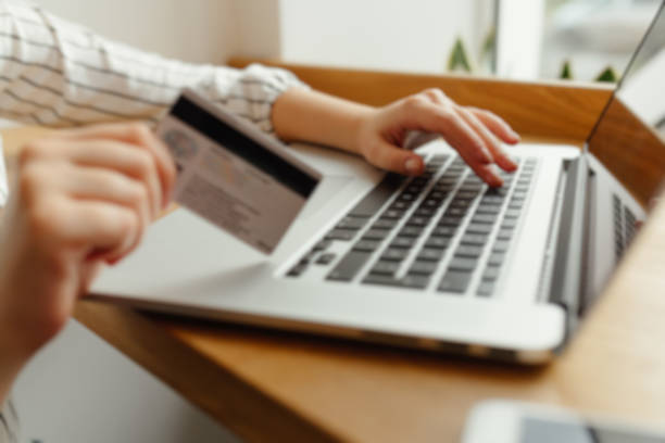 istock Woman with laptop shopping online. Payment Transaction at Computer using Credit Card. Blur image 895051154
