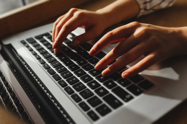 istock Close-up of typing female hands on keyboard 895053704