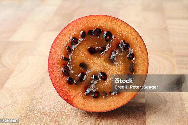 Tamarillo Fruit Cross Section Stock Photo - Download Image Now - Brown Background, Circle, Color Image