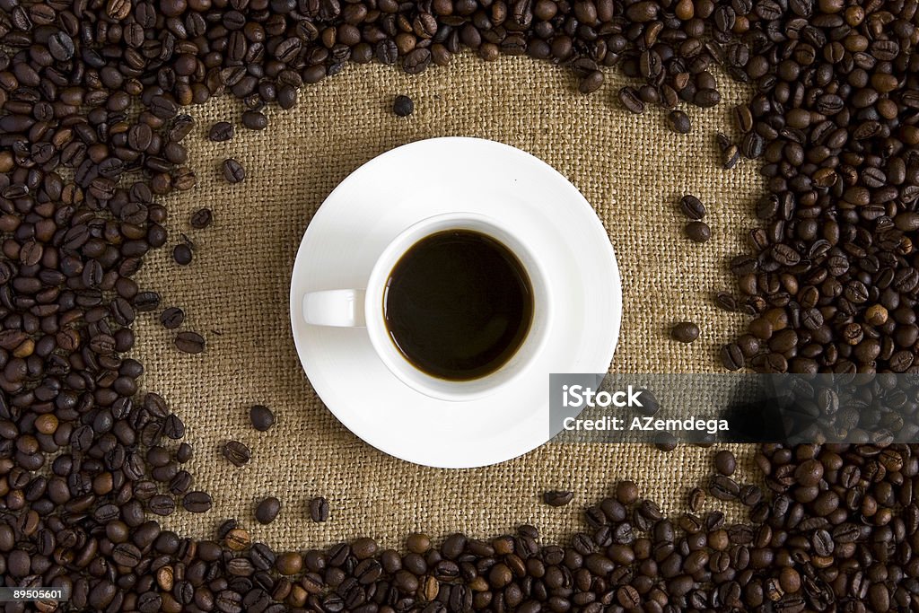 Fresh coffee Hot fresh coffee on burlap between coffee beans Addiction Stock Photo