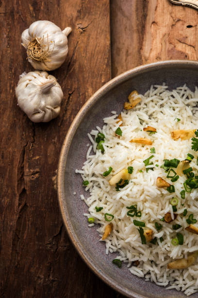 istock Garlic fried rice - cooked white basmati rice fried with garlic and served with yellow dal, popular indian recipe 895061674
