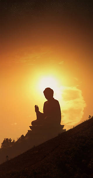 istock Buddha statue at sunset with flaming sun and starscape 89506412