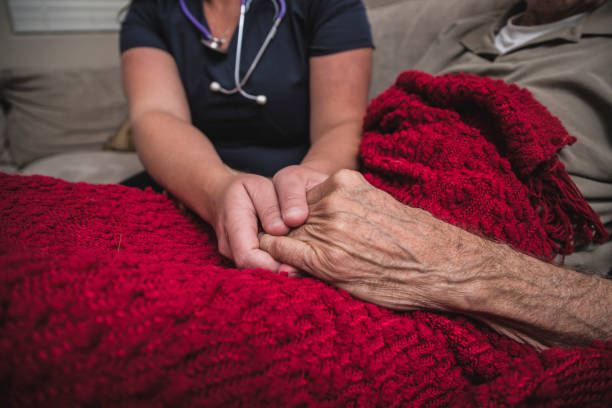 istock Hospice Nurse visiting an elderly male patient 895072196