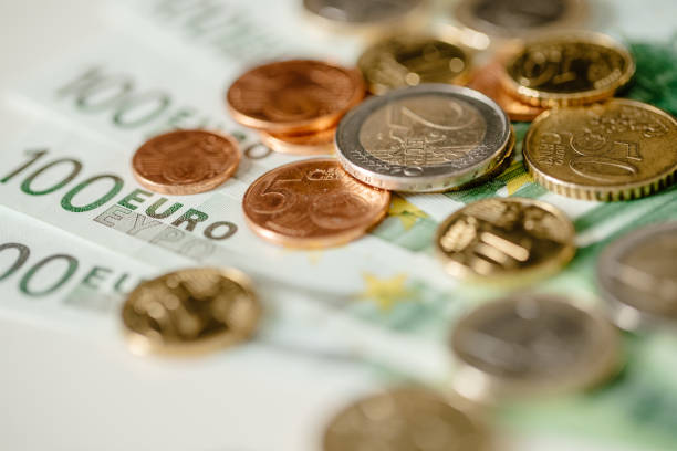 istock One hundred  Euro coins and bills 895072314