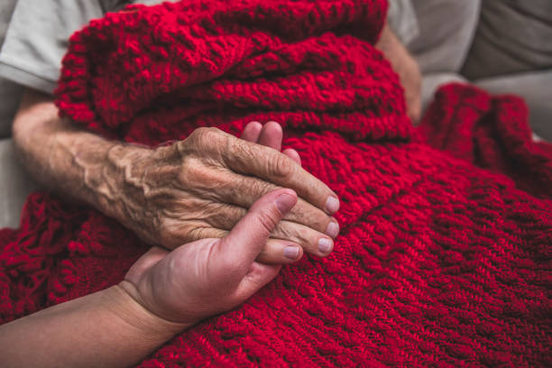 Hospice Nurse visiting an elderly male patient stock photo