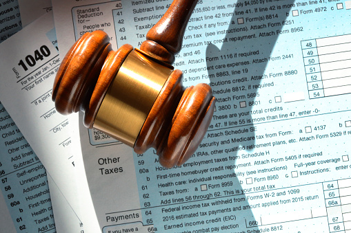 A gavel rests on top of a U.S. federal 1040 tax form.