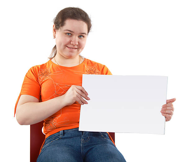 Young woman shows blank card stock photo