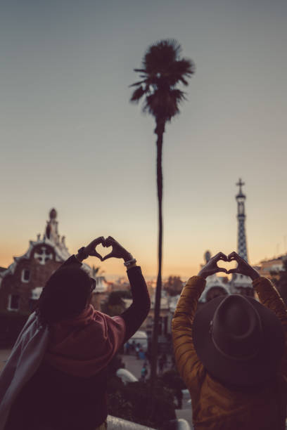 istock Friends at Park Guell making heart symbol with hands 895082170
