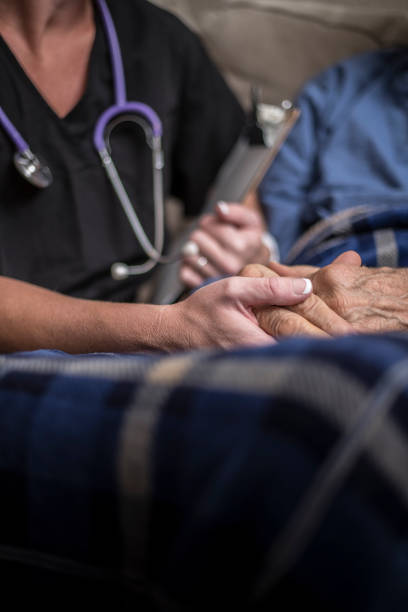 A stock photo of a Hospice Nurse visiting an Elderly male patient who is receiving hospice/palliative care.
