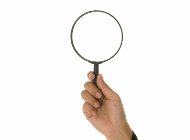 istock Hand holding magnifying glass isolated white background 895088462