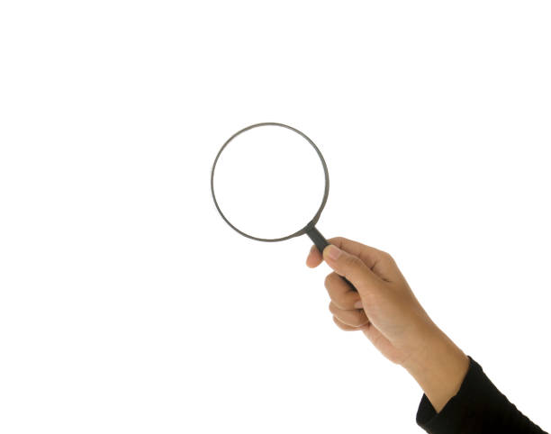 istock Hand holding magnifying glass isolated white background 895088566