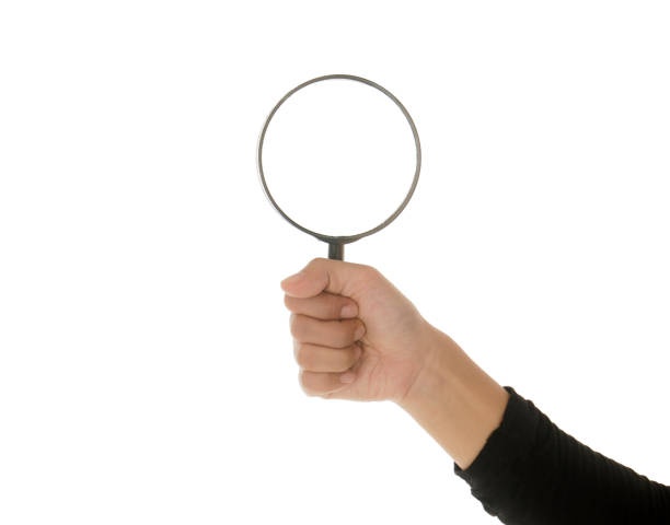 istock Hand holding magnifying glass isolated white background 895088570