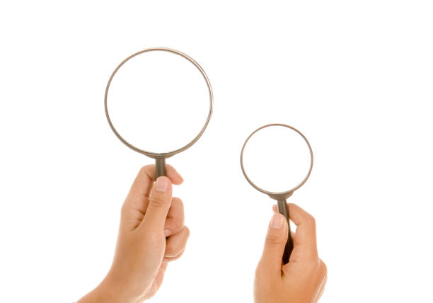 istock Hand holding magnifying glass isolated white background 895088782
