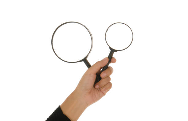 istock Hand holding magnifying glass isolated white background 895092940