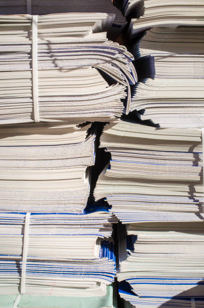 istock Bundles with advertising brochures on sidewalk 895093172