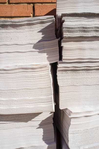 istock Bundles with advertising brochures on sidewalk 895093180
