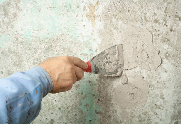 istock Construction and renovation concept. Hand of worker with plastering tools. 895093676