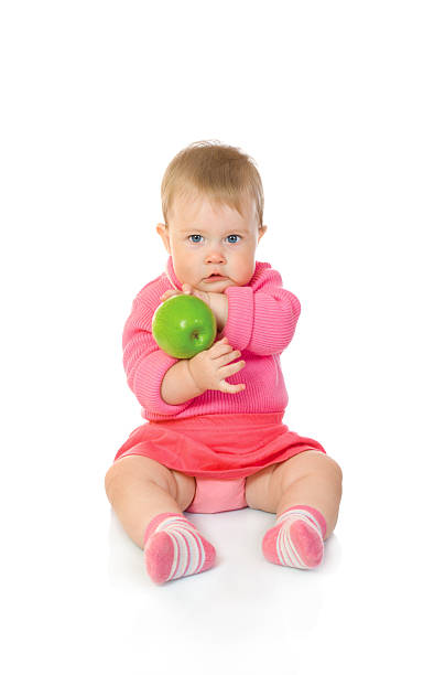 istock Small baby with green apple isolated 89509461