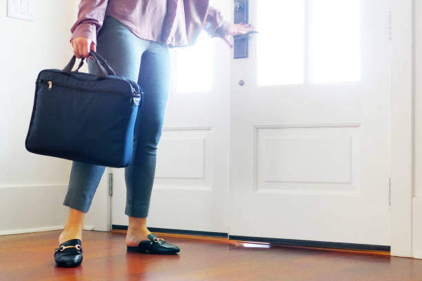 istock Woman walking into home from front door. 895100754
