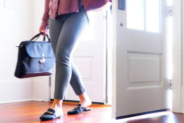 istock Woman walking into home from front door. 895100758