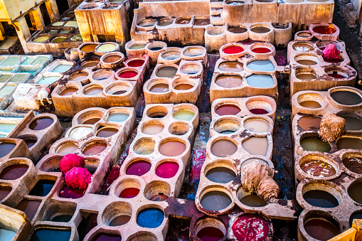 Dye is contained in a large jar, and it is dyed leather.
