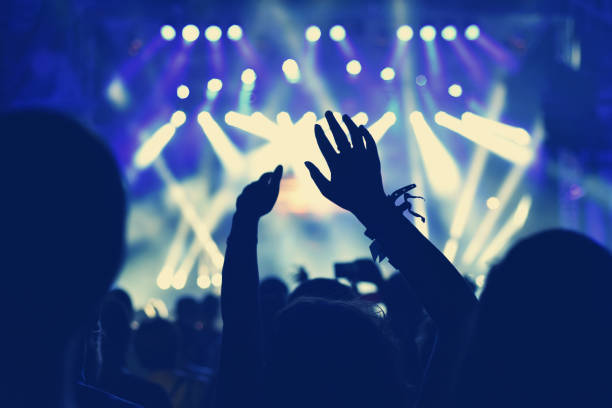 istock Crowd with arms outstretched at concert 895119778