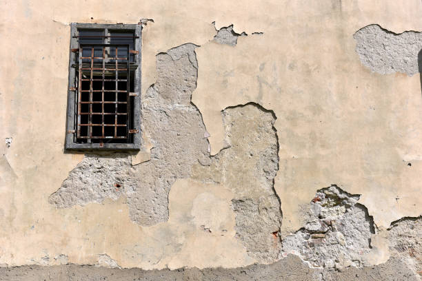 istock Old abandoned building wall with locked windows 895119866