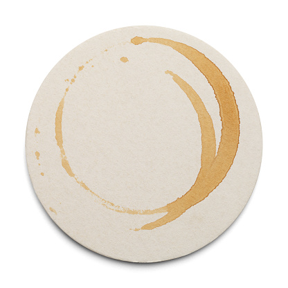 Round Cardboard Coaster With Drink Ring Stains Isolated on White Background.
