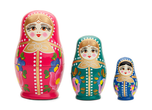 Three Traditional Russian Wood Dolls Isolated on White Background.