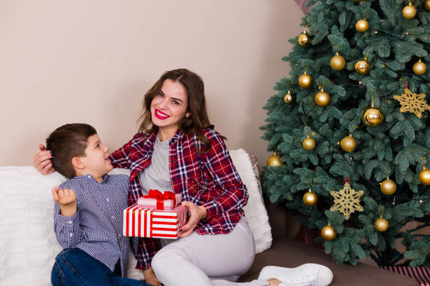 istock Family sitting by the Christmas tree 895127492