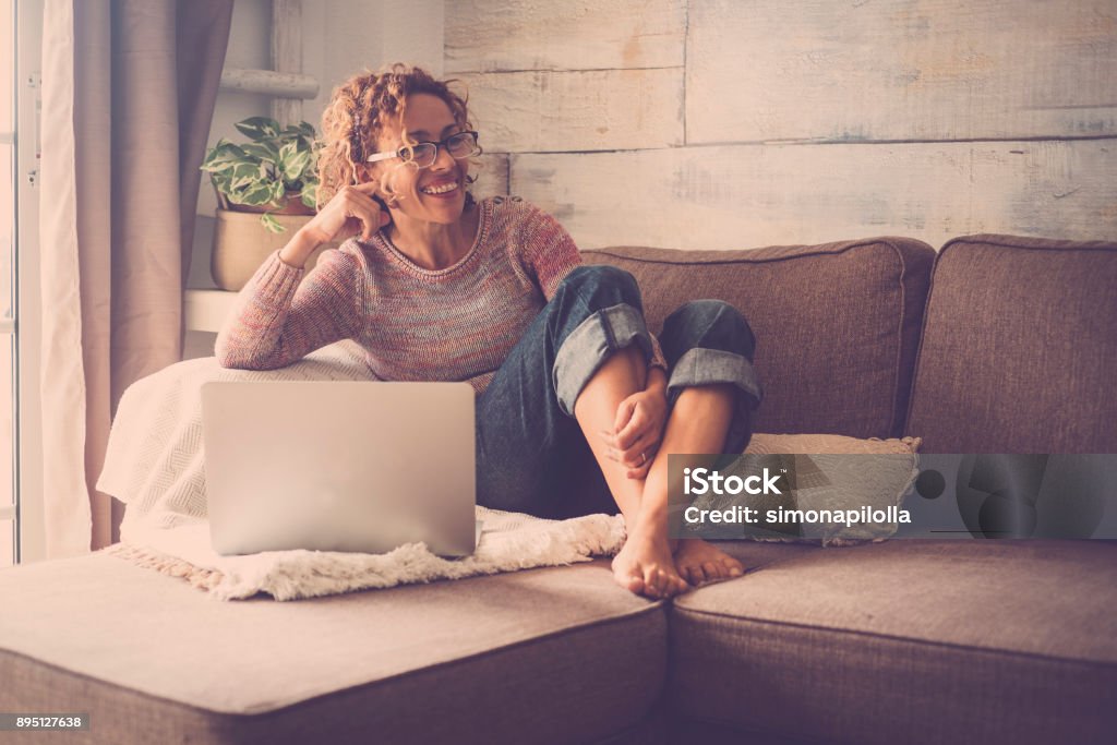 woman on sofa working at the comuter Tranquility Stock Photo