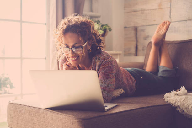 istock woman on sofa working at the comuter 895127668