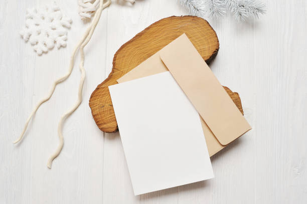 istock Mockup Christmas greeting card letter in envelope with white tree, flatlay on a white wooden background, with place for your text 895129828