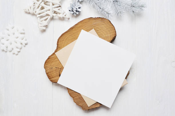 istock Mockup Christmas greeting card letter in envelope with white tree, flatlay on a white wooden background, with place for your text 895129852