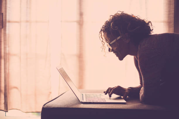 istock woman on sofa working at the comuter 895129904