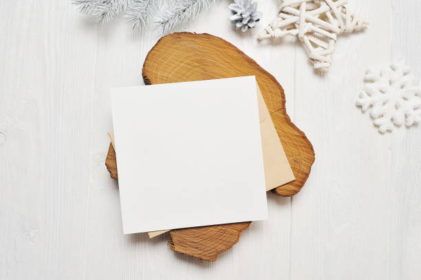 istock Mockup Christmas greeting card letter in envelope with white tree, flatlay on a white wooden background, with place for your text 895129906