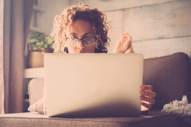 istock woman on sofa working at the comuter 895129976