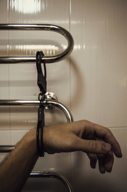 istock Man Pinched by handcuffs to the pipe 895134972