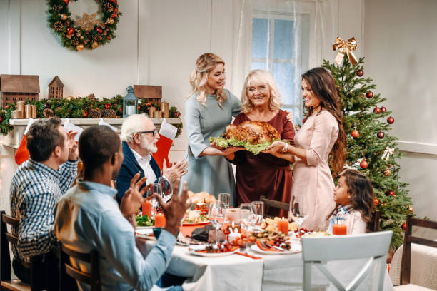 istock women holding christmas turkey 895135252