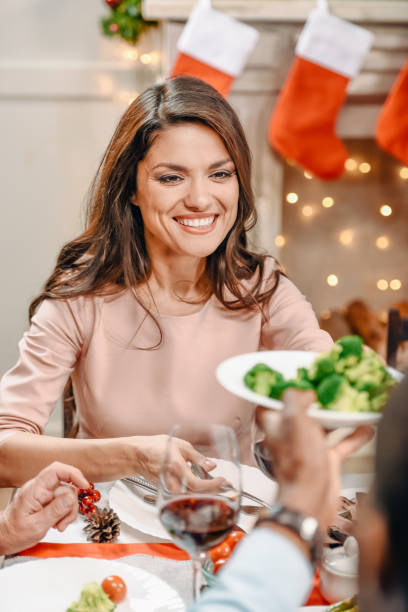 istock young woman on christmas dinner 895135694